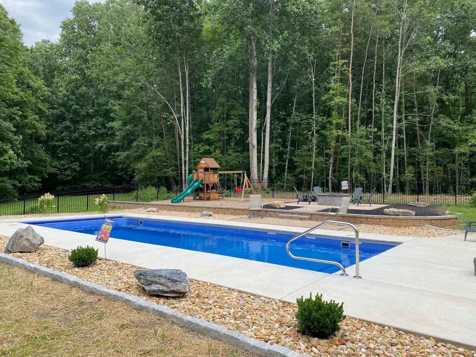 Pool surrounded by river rock and planting